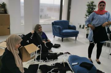 Teenah employees displaying their textiles in an office setting.