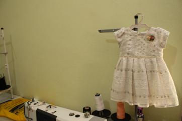 A dress on a stand after being sewn together.