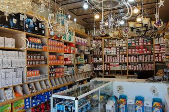 The inside of a store specializing in electronic appliance filled with electrical goods and supplies.