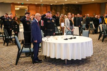 Jordanians, standing, meeting in a conference room.
