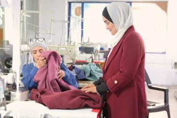 Jordanian woman overseeing operations at her workshop.