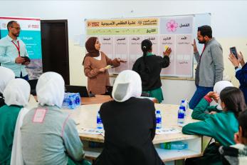 Students learn how to use the interactive weather board during a “climate champions” awareness session. azraq,jordan