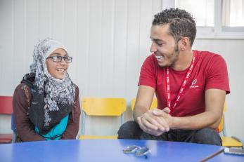 Amani speaking with a mercy corps employee