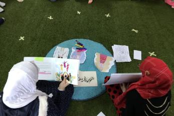 Overhead view of two young women learning.