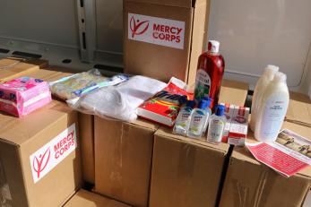 A series of boxes inside a vehicle arranged with personal hygiene and sanitation products.