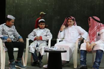 Young people in costume rehearsing for a play.