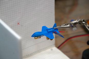 A model plane positioned against a grid during testing by bashar.