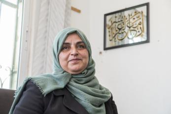 Jordanian woman sitting in living area.