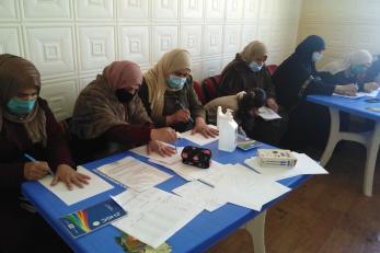 A group of adults tracing their hands. 