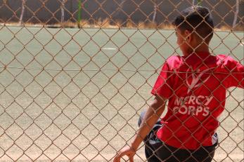 A child wearing a Mercy Corps shirt.