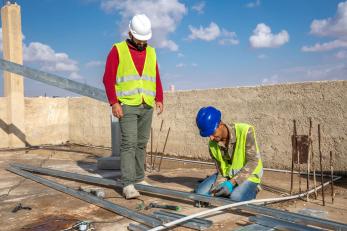 Two people working on a construction project.