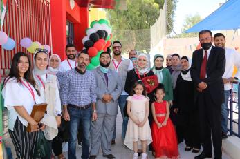 A group of adults and children posing for a photo.