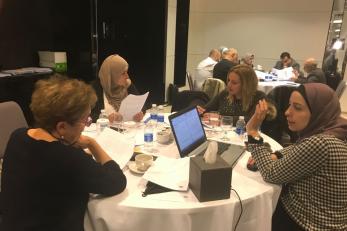 People sitting at a table having a discussion.