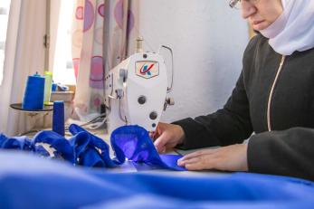 A person operating a sewing machine.
