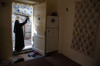 A person looking through a doorway.