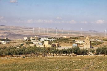 A landscape view of buildings and windturbines.