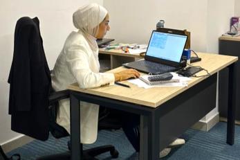woman sitting at computer in office