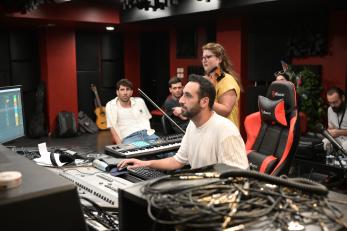 A group of creatives work in a sound studio in Jordan.