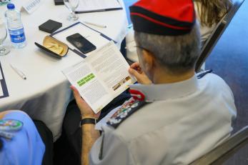 Image of the perspective of looking over an official's shoulder while he reads a document.