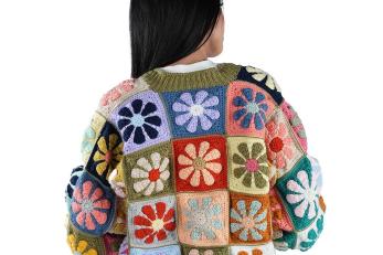 Jordanian woman, with her back to camera, modelling a knit sweater.