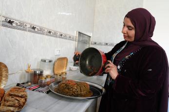 Jordanian woman in kitchen preparing delicious dishes.