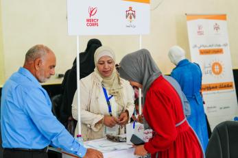 Jordanian community members at a conference desk.