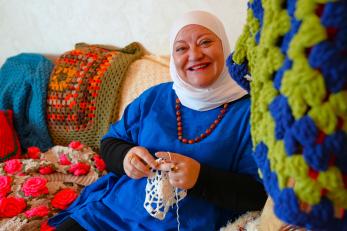 Areej Malkawi, owner of Magic Loops, works working on a handmade crochet piece in her small shop in Amman.