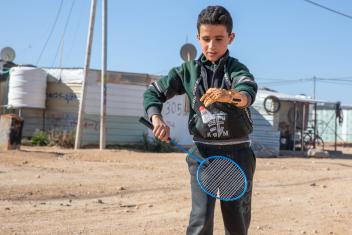 Mohammad plays badminton with friends, the first time with two hands.
