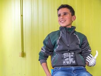 Syria boy with 3d-printed prosthetic hand.