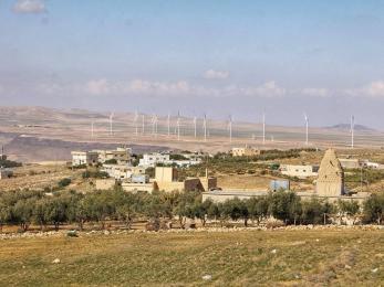 A landscape view of buildings and windturbines.