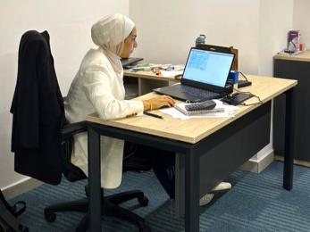 woman sitting at computer in office