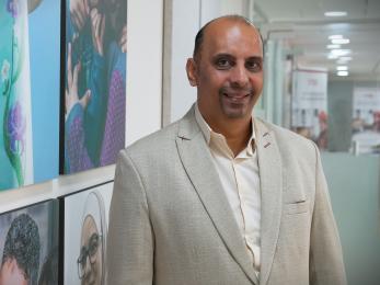 A person standing and smiling for the photo.