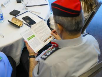 Image of the perspective of looking over an official's shoulder while he reads a document.