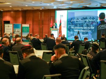 Jordanians meeting in a conference room with a speaker as center of attention.