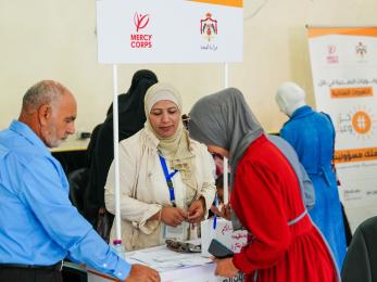 Jordanian community members at a conference desk.
