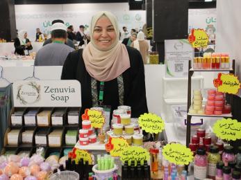 A business owner showcasing their newly wrapped products.