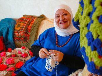 Areej Malkawi, owner of Magic Loops, works working on a handmade crochet piece in her small shop in Amman.